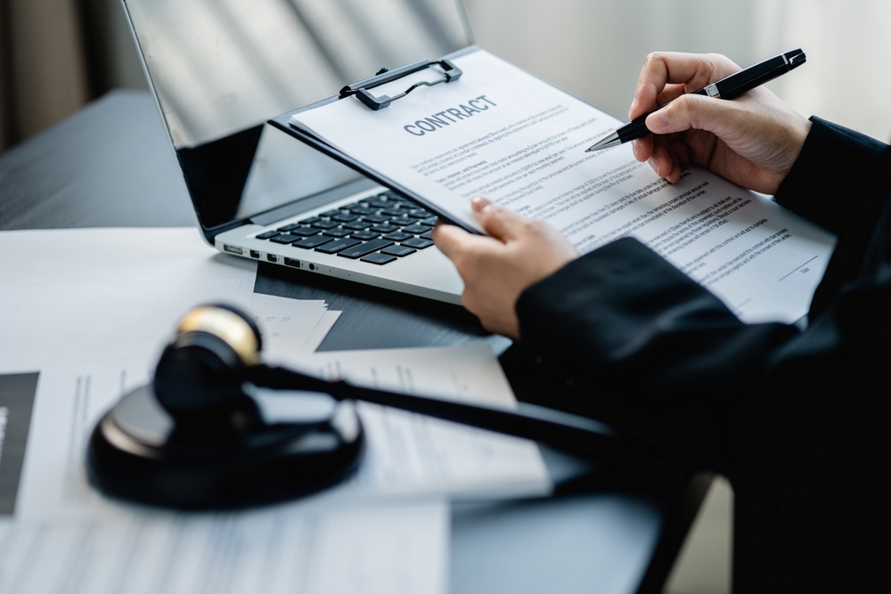 Businesswoman or Female lawyer drafting a business contract in a law firm.