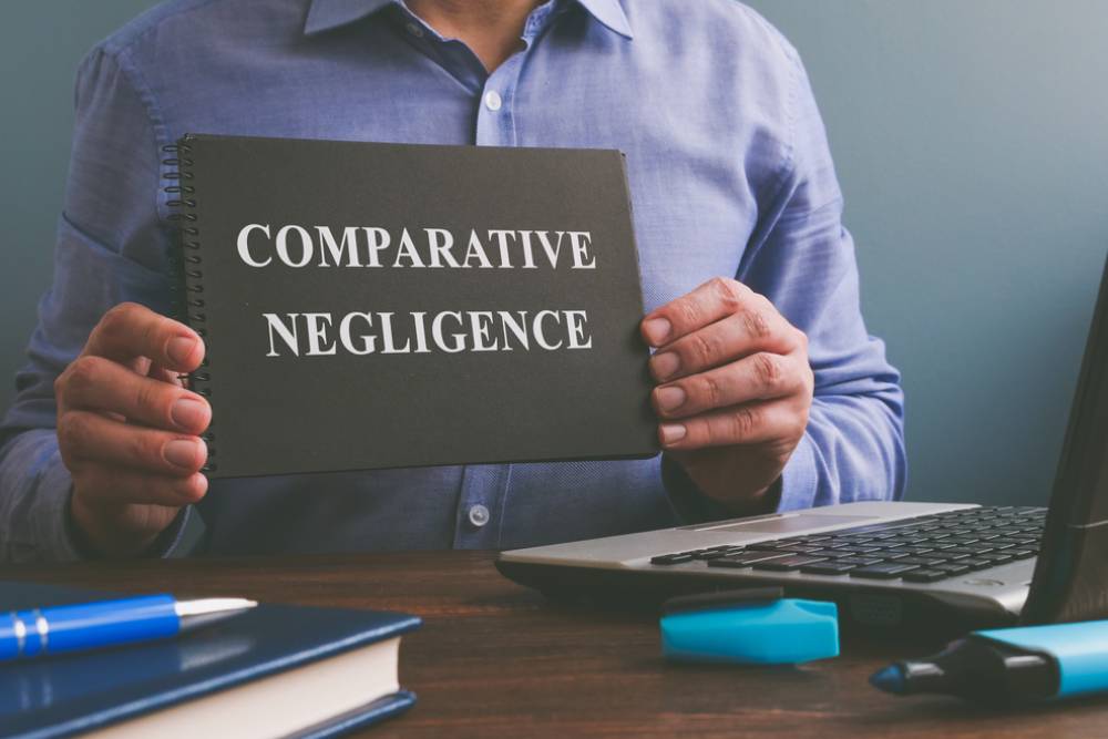Man shows Comparative negligence data in the book.